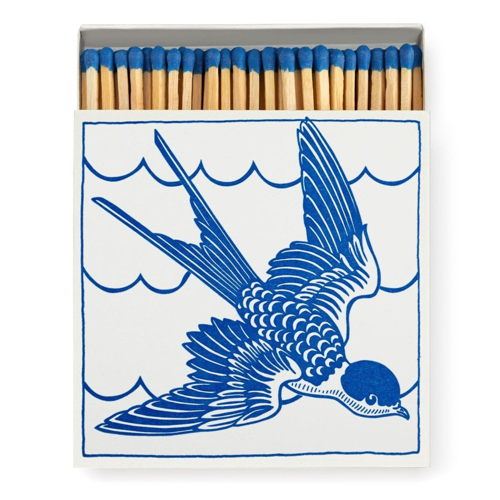 A decorative matchbox with a blue bird on it.