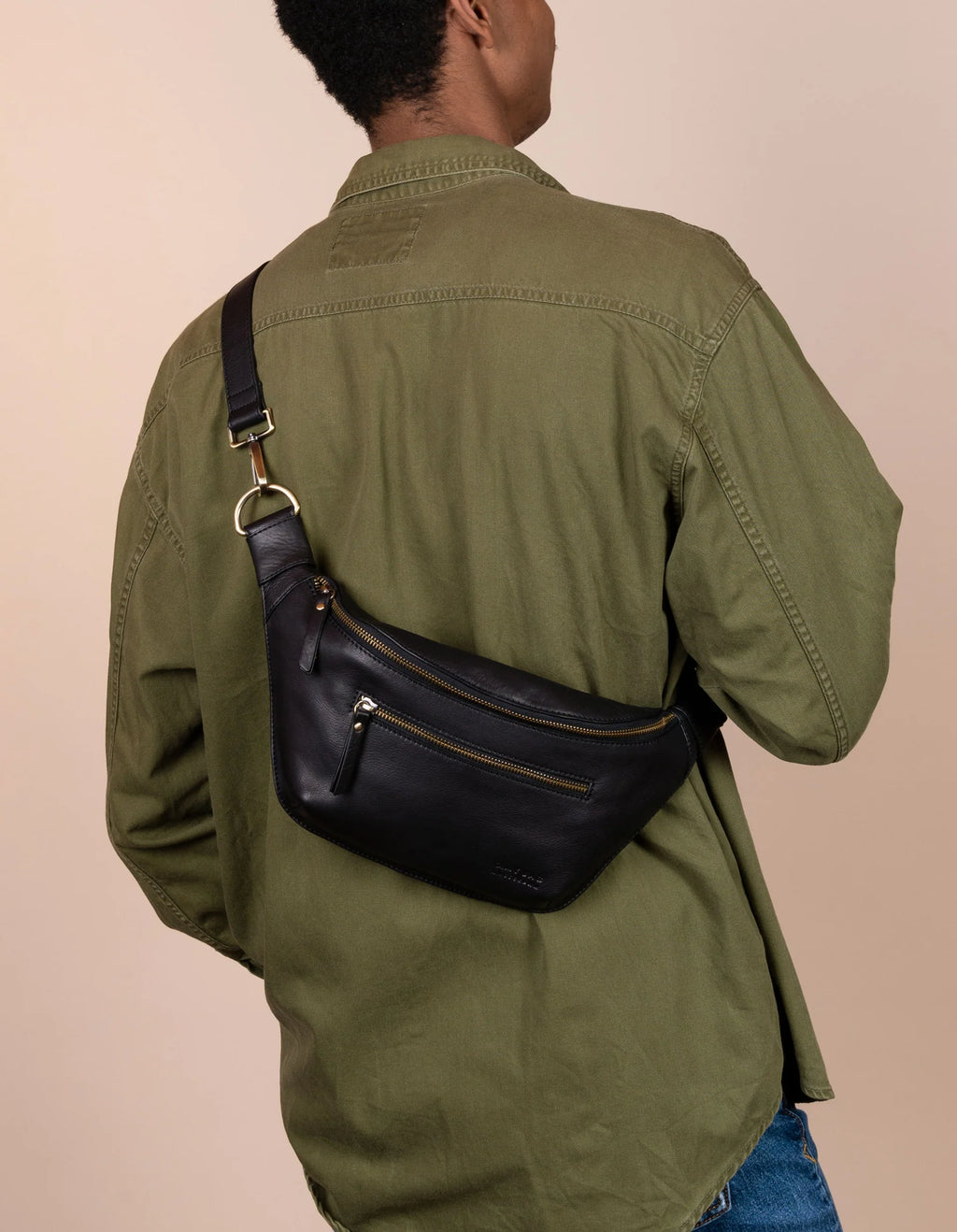 Person wearing black soft grain leather bum bag