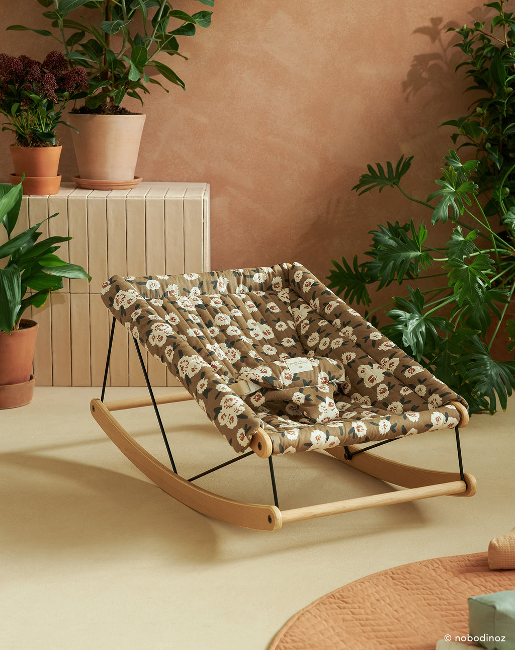 Growing Green Baby Bouncer in well decorated room.