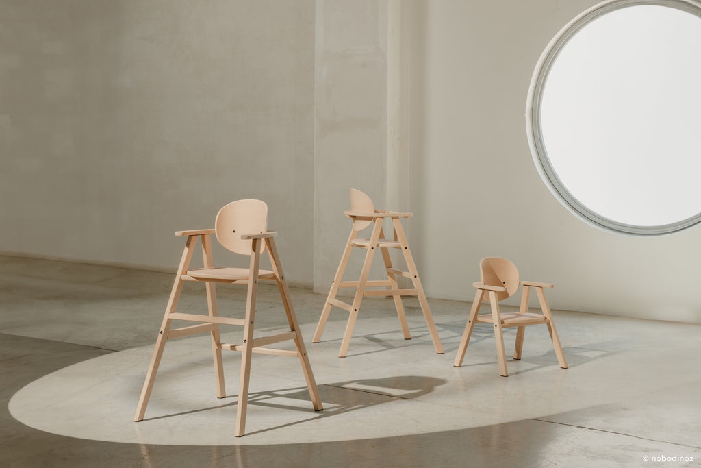 A closer shot of all three versions of the evolving wooden high chair