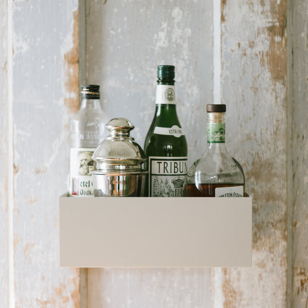 A Planter Wall Box being repurposed to hold bar and cocktail accoutrements