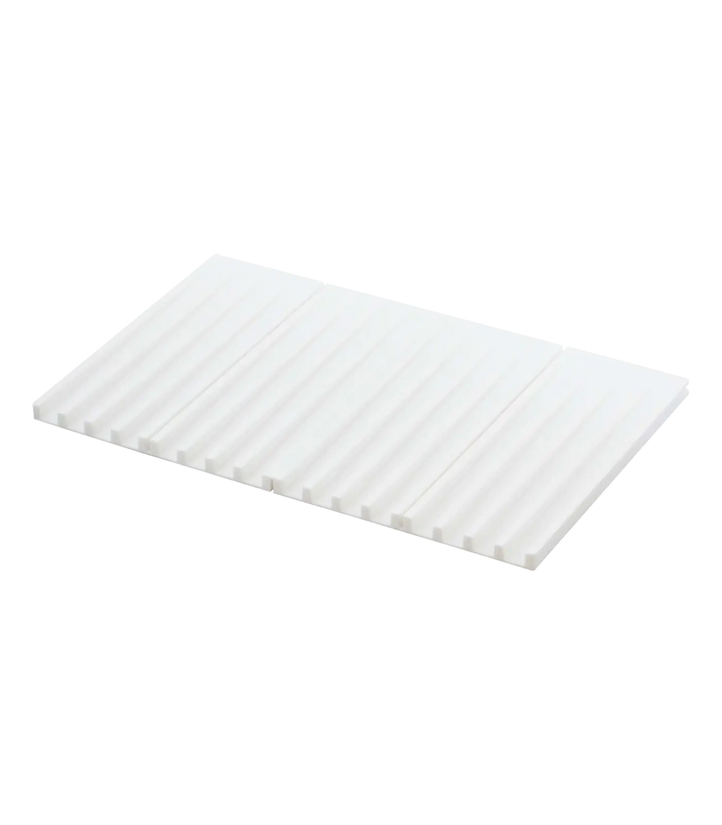 A white rectangular corrugated silicone drying mat with a ribbed surface, shown at an angle on a plain white background.