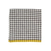 A folded checkered napkin with a black and white gingham pattern and a solid mustard yellow fringed border, shown on a plain white background.