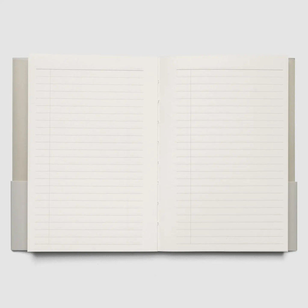 An open lined notebook or journal with blank white pages, shown against a light gray background.