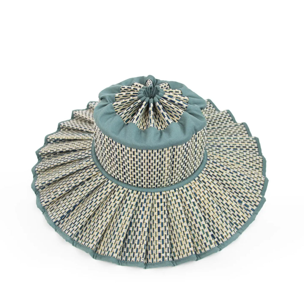 Decorative woven hat with a blue top on a white background