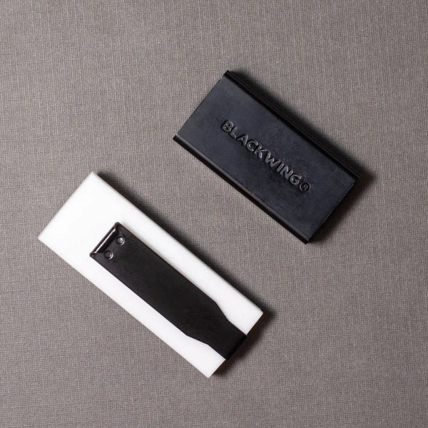 White eraser with 'BLACKWING' branding on a gray surface