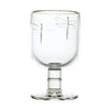 Clear glass goblet with dragonfly design on a white background