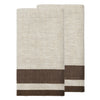 Two folded woven towels in a light beige and white herringbone pattern with a contrasting dark brown stripe near the bottom, displayed on a solid white background.