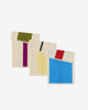 Three cotton towels with different color patterns on a white background