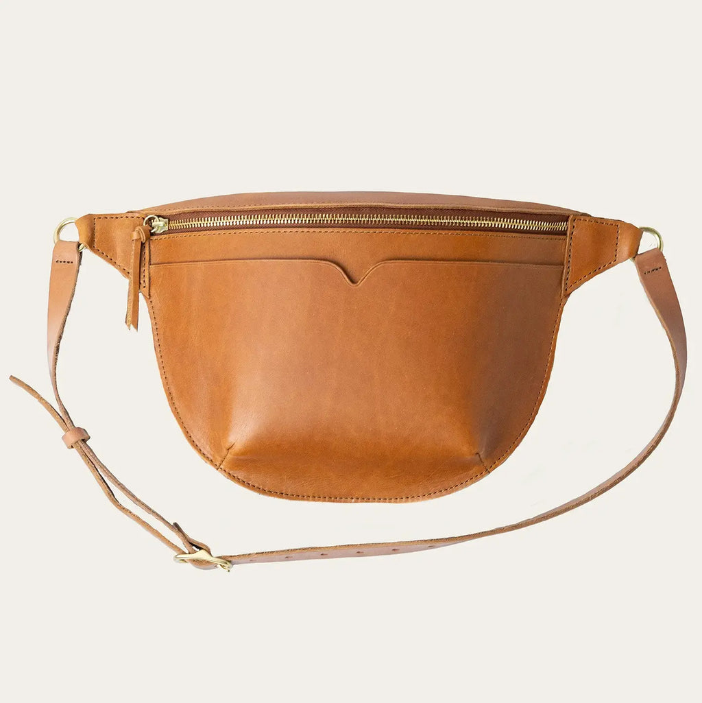 Brown leather crossbody bag on a beige background