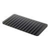 A dark gray rectangular mat with parallel raised ridges, shown at an angle on a plain white background.
