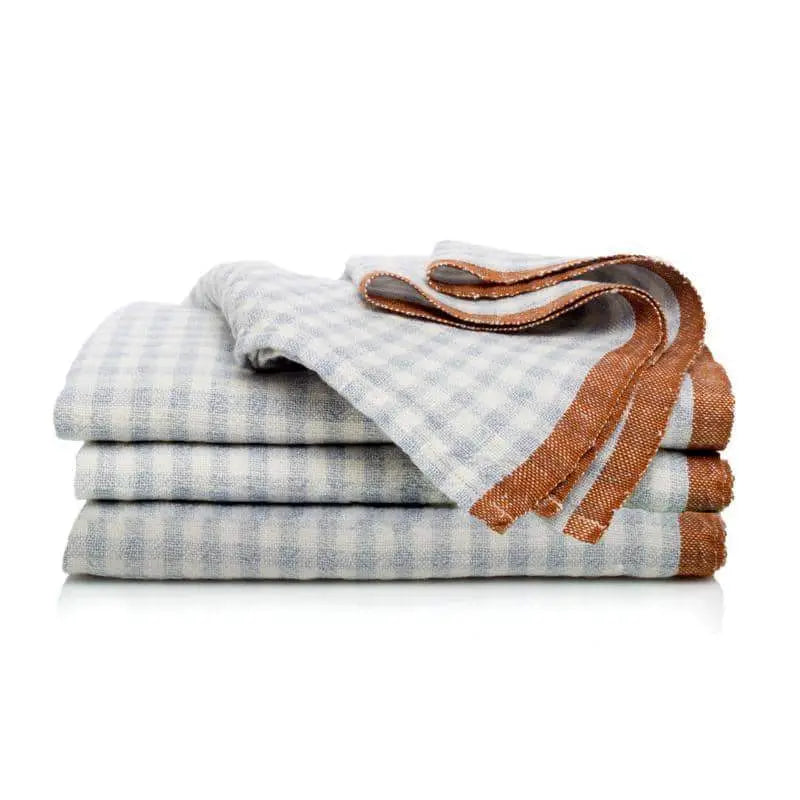 Stack of folded checkered napkins with a brown border on a white background