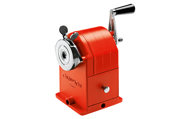 Red manual pencil sharpener on a white background