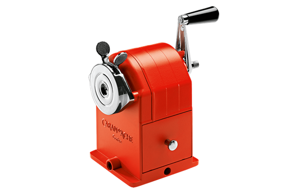 Red manual pencil sharpener on a white background