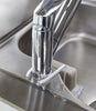 Chrome kitchen faucet on a stainless steel sink