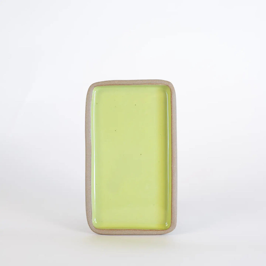 Rectangular ceramic dish with a light green interior on a white background