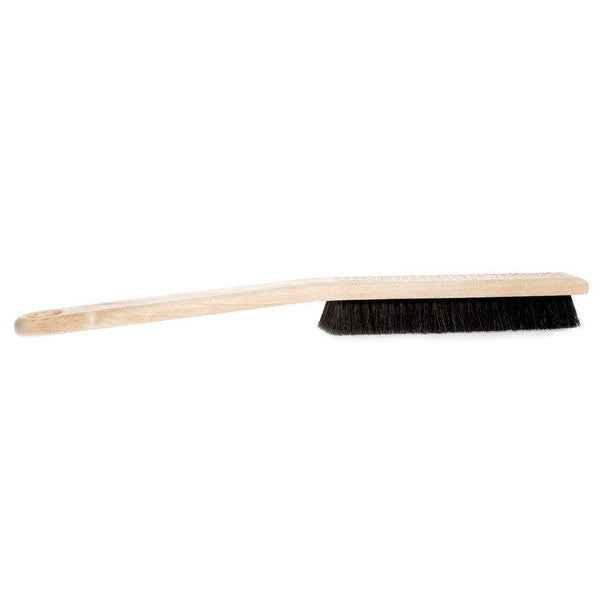Cleaning brush with wooden handle and black bristles on a white background