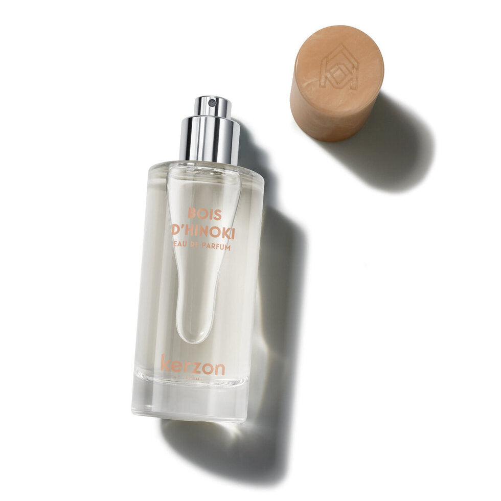 Perfume bottle with a brown cap on a white background