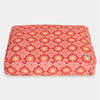 Red and yellow patterned pet bed on a white background