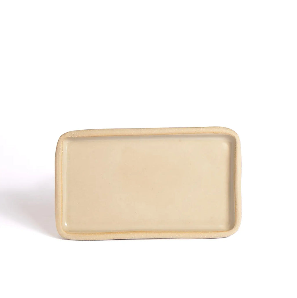 Rectangular beige ceramic plate on a white background