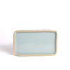 Rectangular ceramic plate with light blue glaze and beige rim on a white background