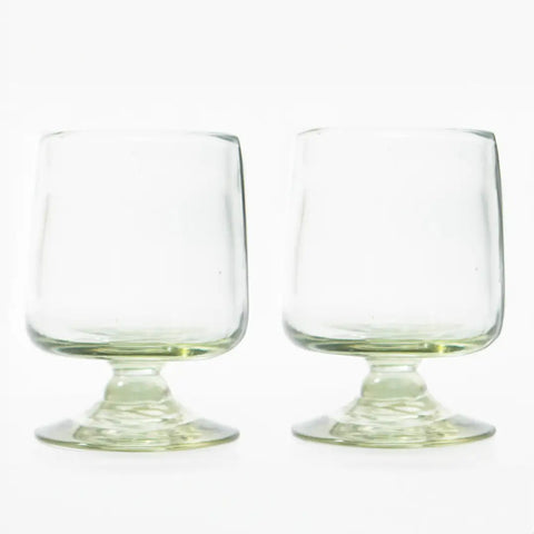 Two clear glass tumblers on a white background