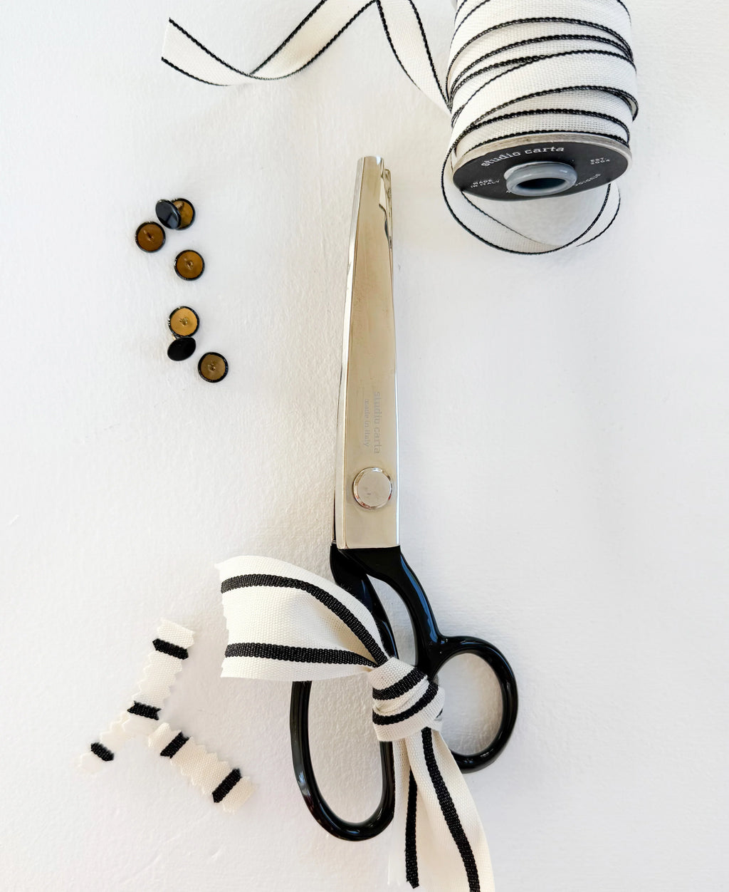Scissors with a decorative bow on a white background