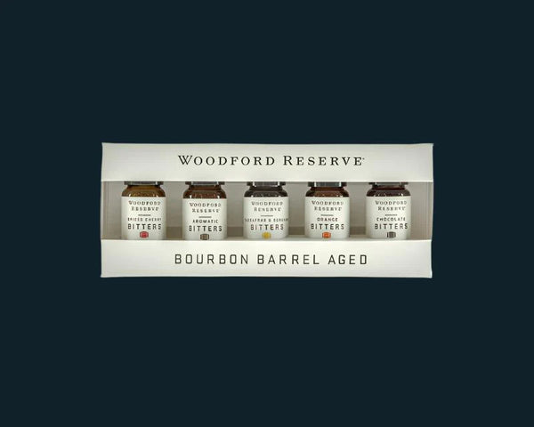Woodford Reserve bourbon barrel aged bitters set on a black background