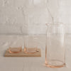 Mid-century modern shape glass pitcher in peach and clear.