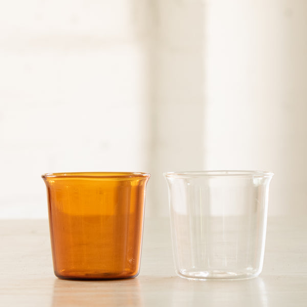Small amber and clear drinking glasses